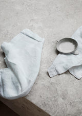 Mint linen napkins on stone surface.